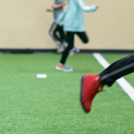 kids running on the green turf