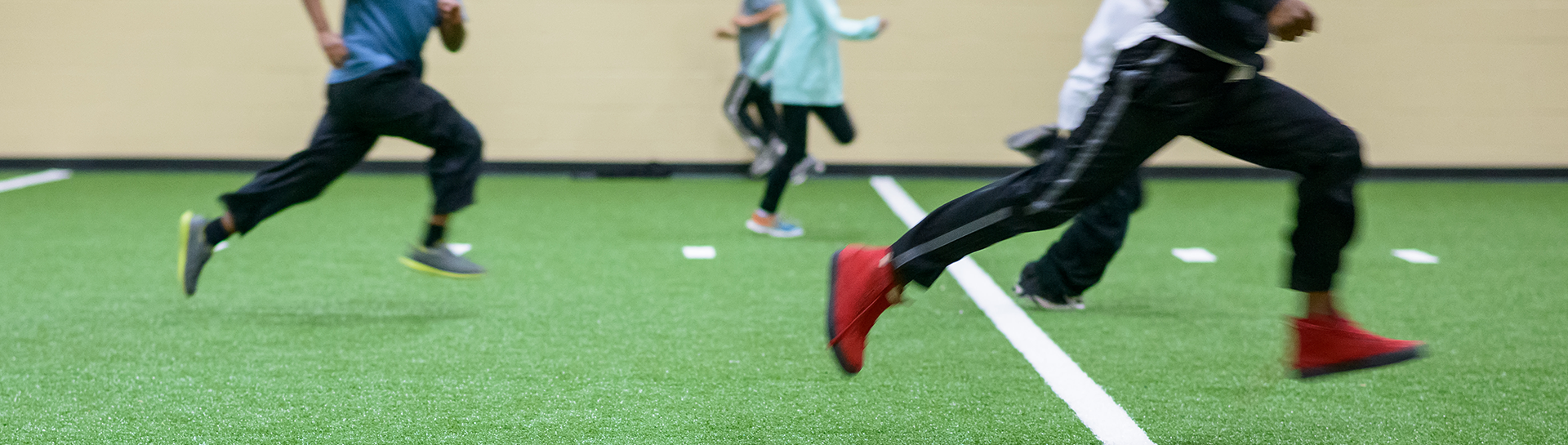 kids running on the green turf