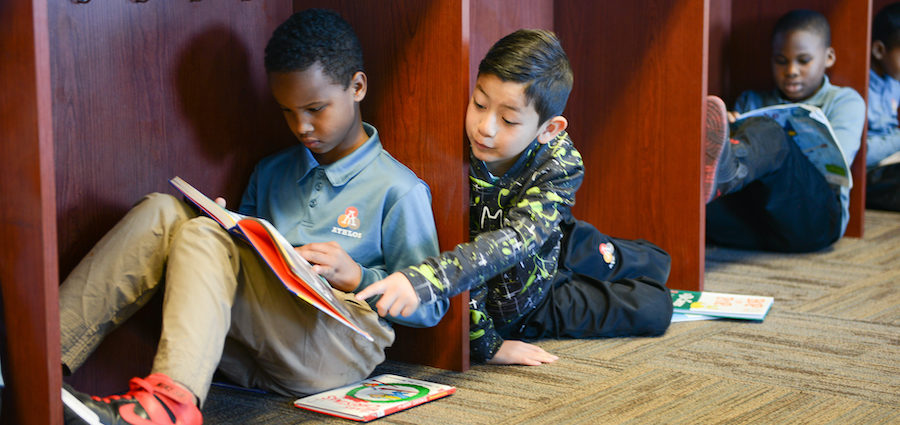 Three boys reading together