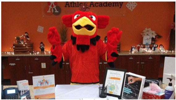 photo of Griffin Mascot at the front desk waving
